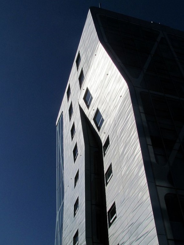 The glass and metal facade splits up in the east side