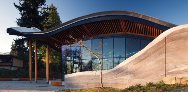 The building is surrounded by undulating walls of rammed earth. 