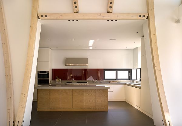 The kitchen can be seen through the foudre wall